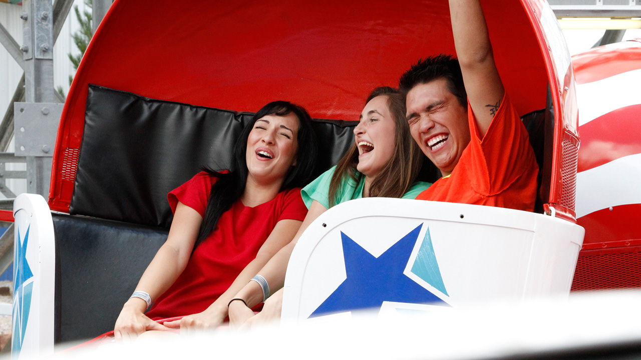 Guests riding the Tilt-a-Whirl during the day